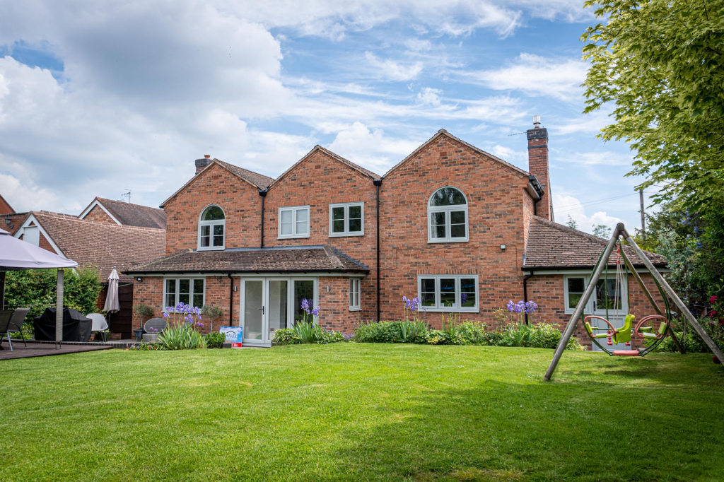 Sage green window frames with matching door frames
